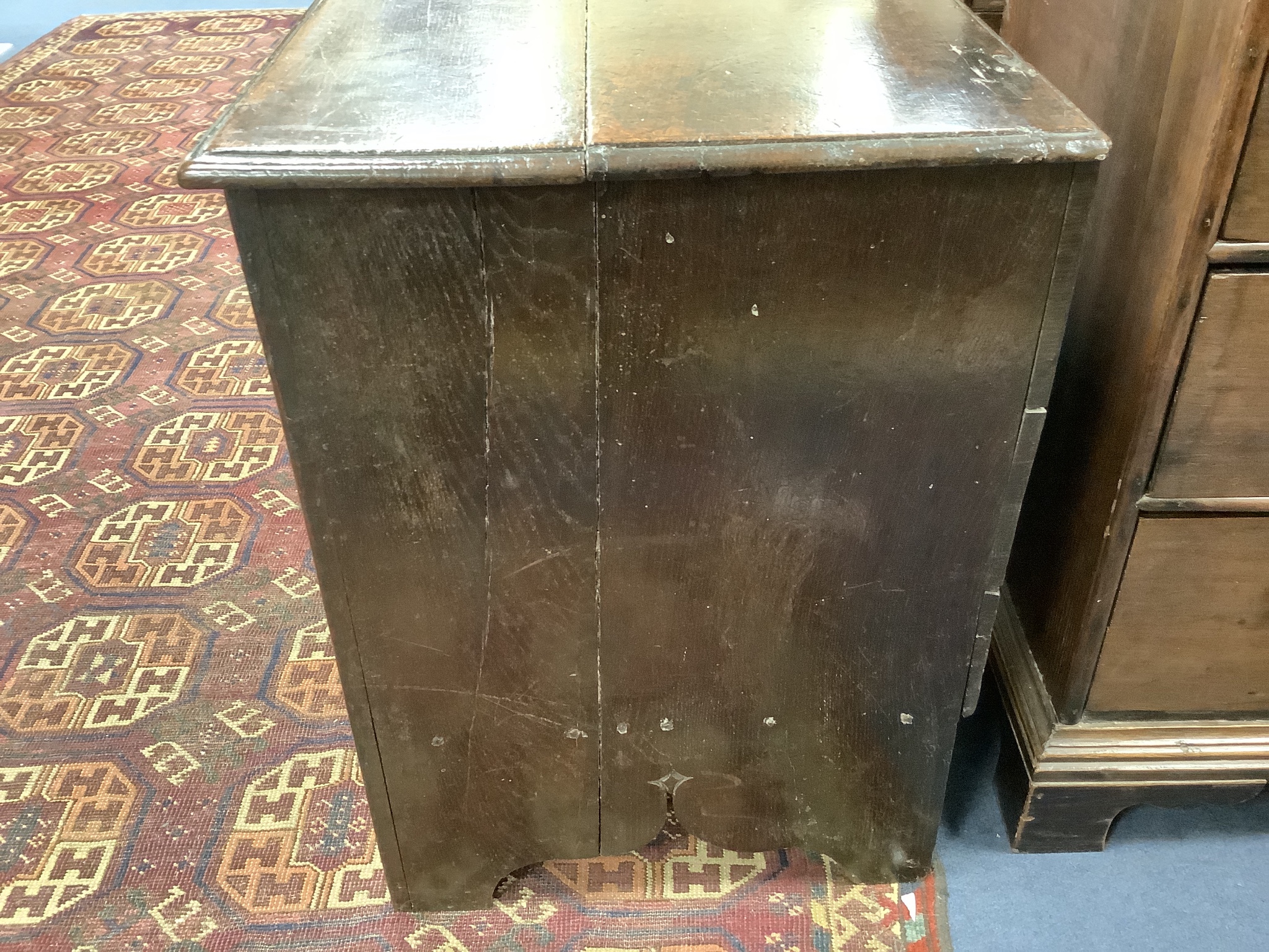 A 17th century carved boarded and panelled oak chest with rectangular moulded top, length 97cm, depth 48cm, height 64cm